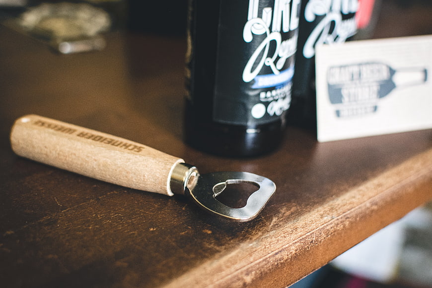 Wooden Handle Bottle Opener on Rustic Table