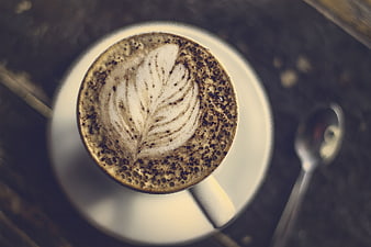 Top View of Cappuccino with Latte Art on Dark Table