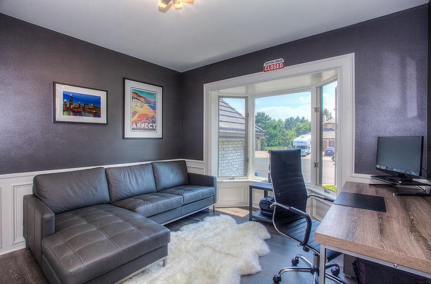 Modern home office with gray sectional sofa and desk