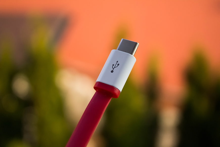 Close-up of red USB-C cable connector outdoors