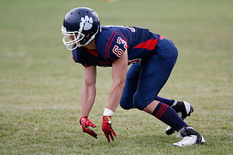 American Football Player in Blue Uniform Ready Stance