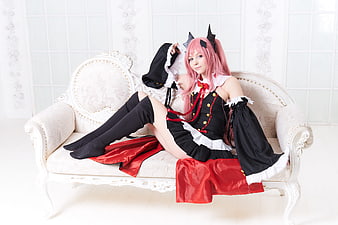 Pink-Haired Cosplayer in Black and Red Dress on White Sofa