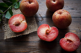 Fresh Red Plums on Rustic Wooden Table