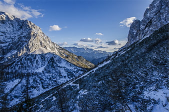 Snowy Mountain Valley with Blue Sky and Clouds