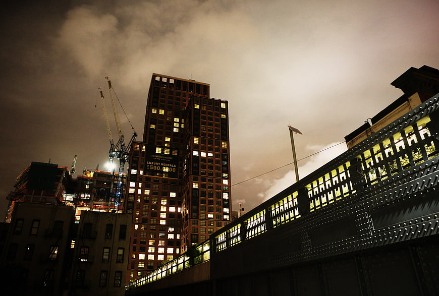 Night view of city skyscraper and bridge construction