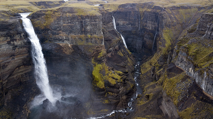 Aerial View of Majestic Waterfalls in Icelandic Canyon