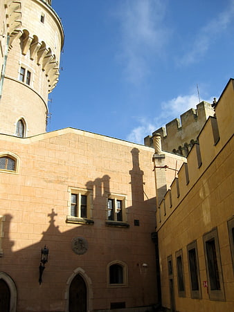 Low angle view of Bajmóc Castle architecture against blue sky
