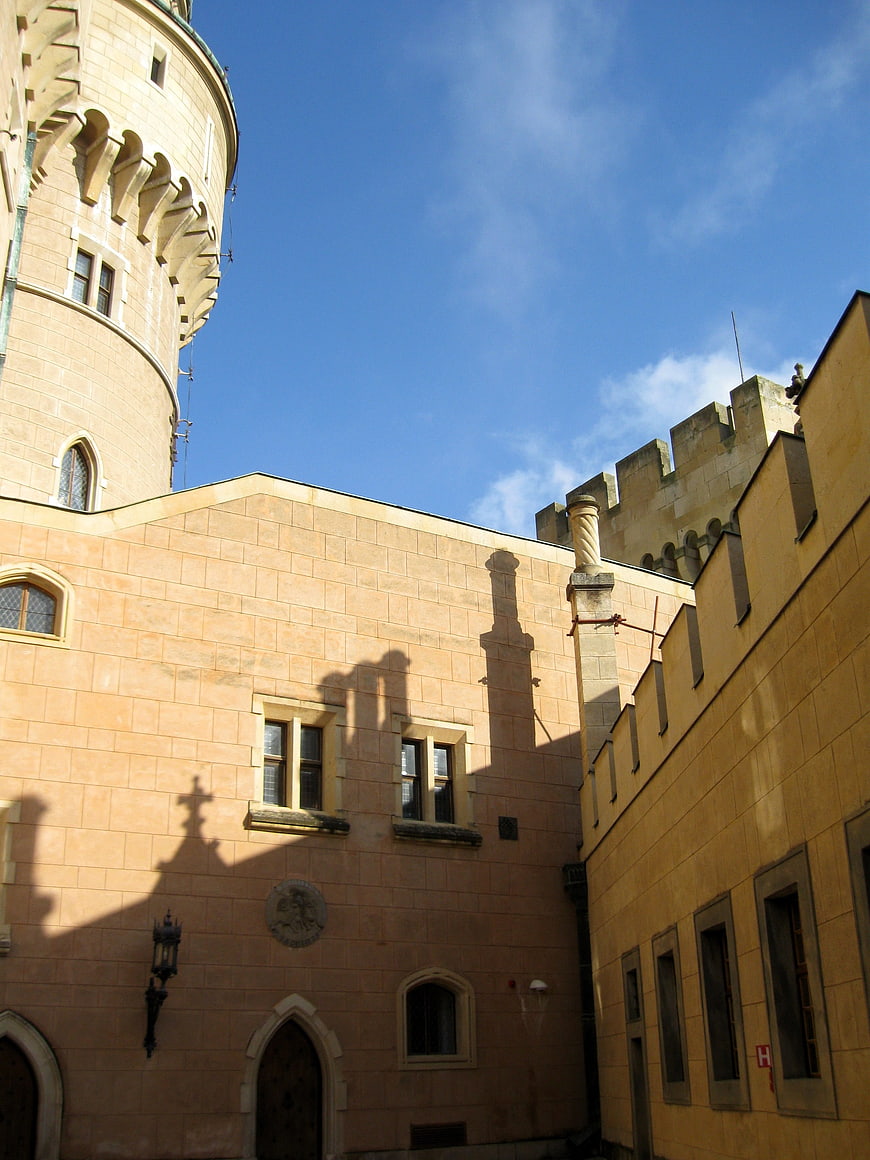 Low angle view of Bajmóc Castle architecture against blue sky
