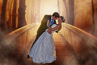 Romantic Wedding Couple Dancing on Misty Wooden Bridge in Autumn Forest