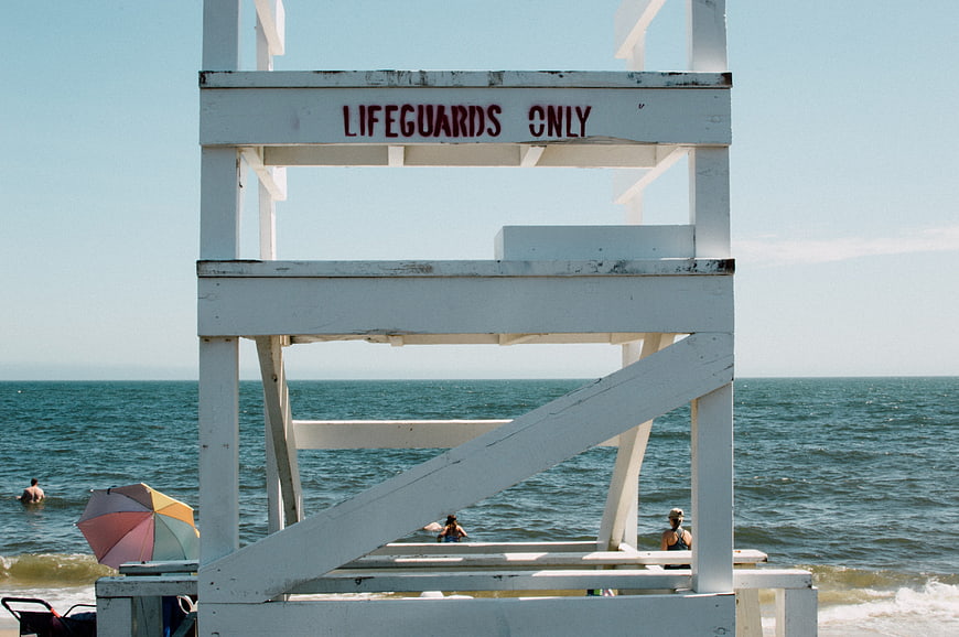 White Lifeguard Tower on Beach with Ocean Background