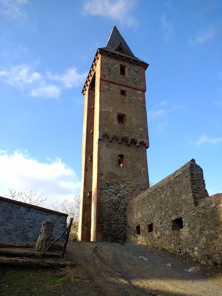 Medieval stone tower ruin against blue sky