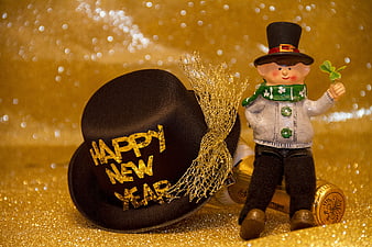 Happy New Year Top Hat and Figurine on Gold Background