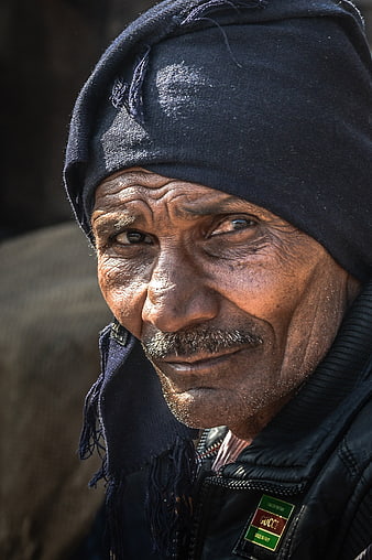 Close-up portrait of elderly Indian man with weathered face