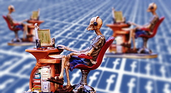 Skeleton figurine using computer with Facebook background