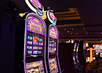 Illuminated slot machines in a dark casino interior