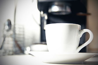 White Coffee Cup on Saucer with Blurred Background