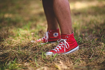 Close-up of red high-top sneakers on grass