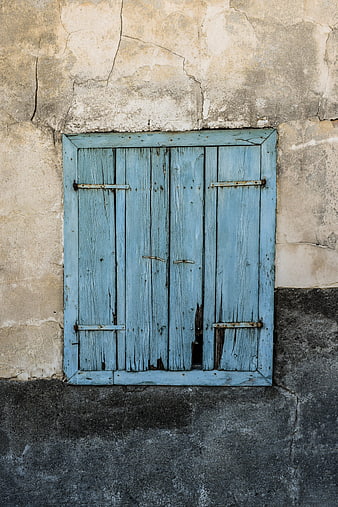 Weathered Blue Wooden Shutters on Cracked Wall
