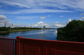 Red Bridge Overlooking River and Industrial Landscape