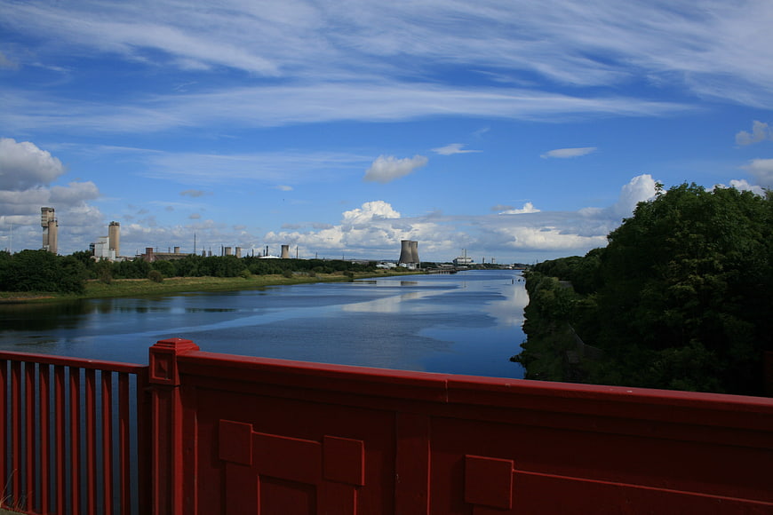 Red Bridge Overlooking River and Industrial Landscape