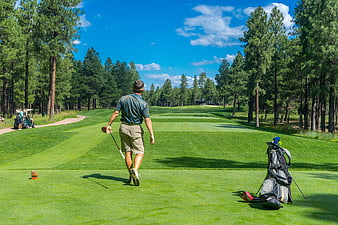 Golfer Walking on Fairway with Golf Bag and Club
