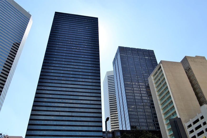 Low angle view of modern glass skyscrapers against blue sky