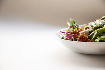 Healthy Green Salad with Lentils and Croutons in White Bowl