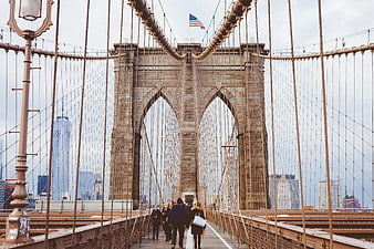 Brooklyn Bridge Pedestrians with Manhattan Skyline Background