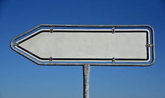 Empty White Arrow Traffic Sign Against Clear Blue Sky