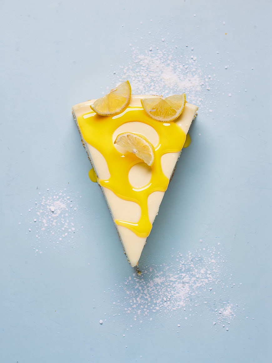 Lemon Cheesecake Slice on Blue Background