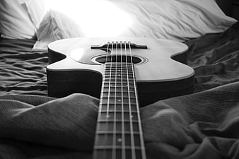 Acoustic Guitar on Bed in Black and White