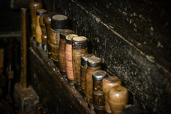 Vintage wooden chisels in a rustic workshop tool rack