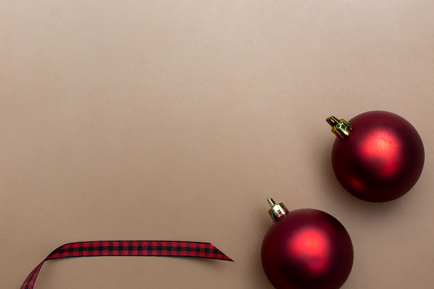 Minimal Red Christmas Baubles and Ribbon on Beige Background