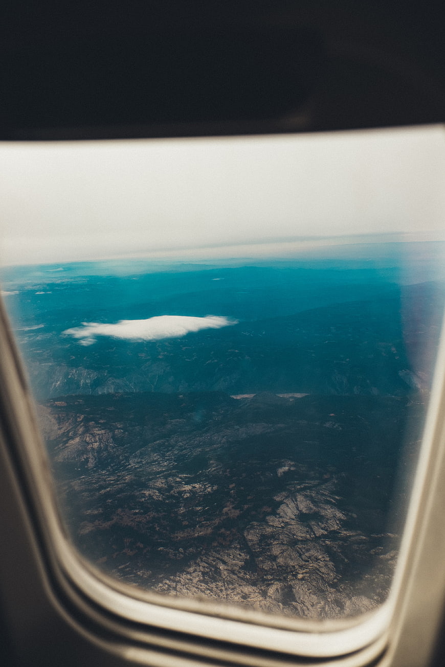 Aerial View of Mountains Through Airplane Window
