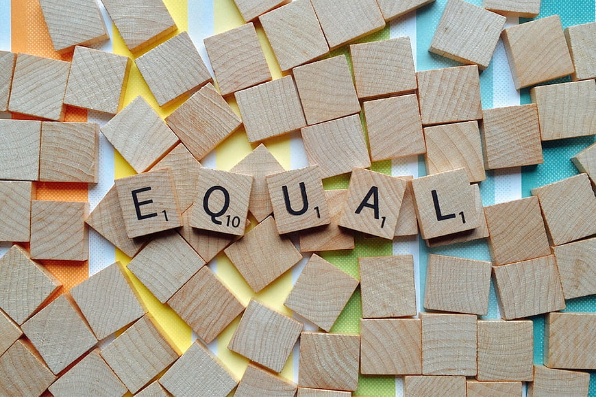 Scrabble Tiles Spelling Equal on Colorful Background