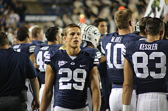 American Football Player in Navy Blue Jersey on Field