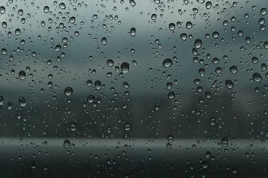 Raindrops on a Window Pane with Blurred Background