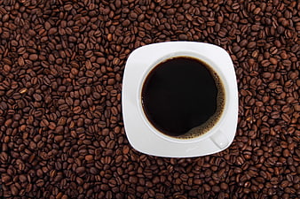Top View of Black Coffee Cup on Roasted Coffee Beans