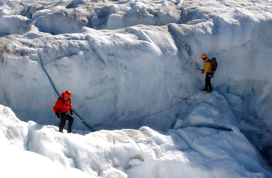 Two Ice Climbers Crossing a Glacial Crevasse