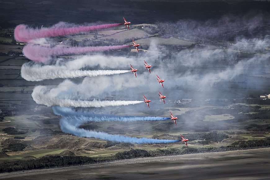 Red Arrows RAF jets in formation with colored smoke trails