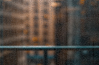 Raindrops on Window Glass with Blurred City Background