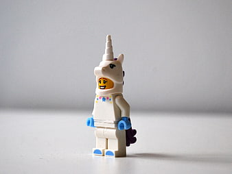 Lego Minifigure in White Unicorn Costume on Gray Background