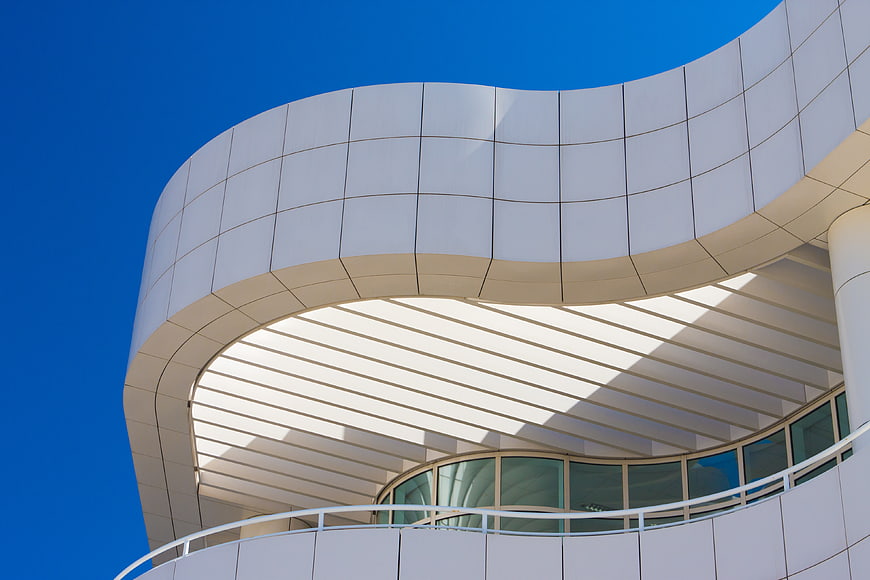 Modern white curved architecture against blue sky