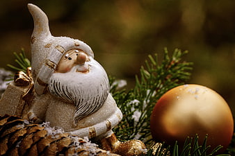 Snowy Christmas Gnome Figurine With Pine Branches And Gold Ornament