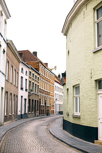 Cobblestone street in historic European city with colorful buildings