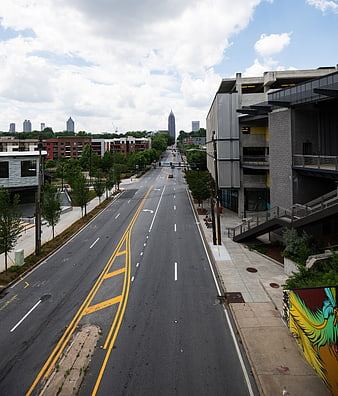 Wide Urban Street View with City Skyline and Modern Buildings