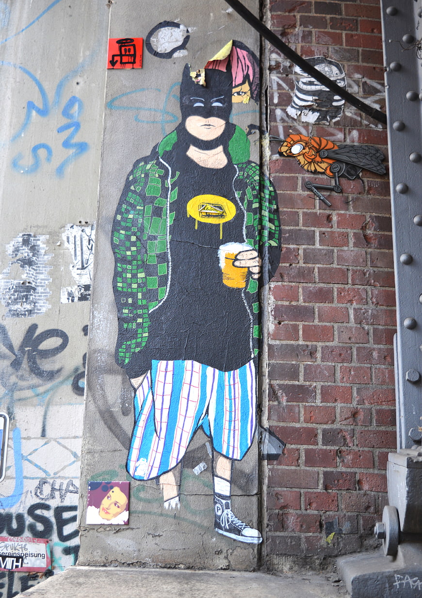Street Art Mural of Batman Character with Beer on Urban Wall