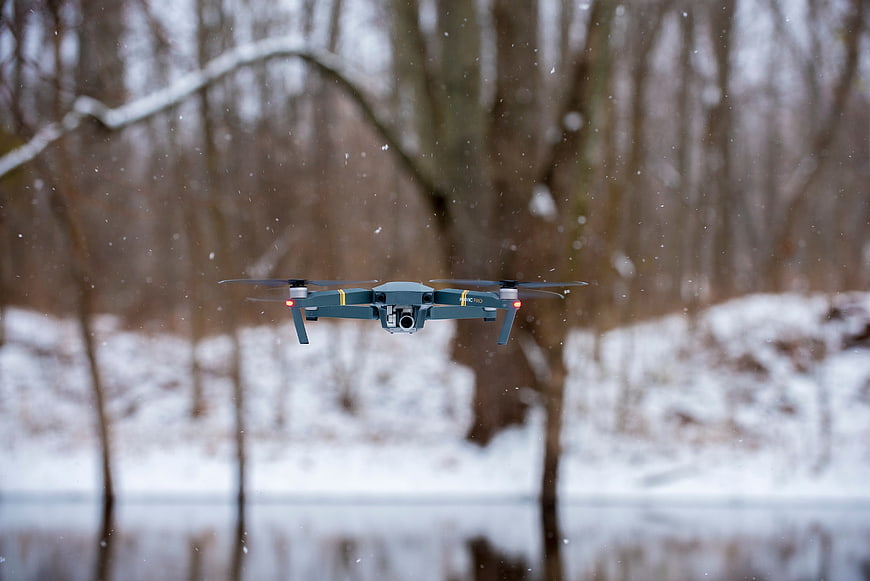Drone Flying in Snowy Winter Forest Landscape
