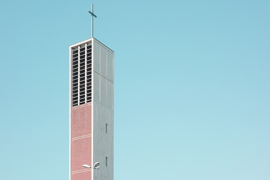 Modern Church Bell Tower Against Blue Sky