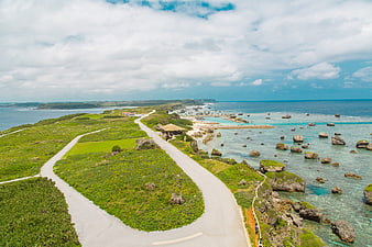 Aerial view of winding coastal road with turquoise ocean and rocks